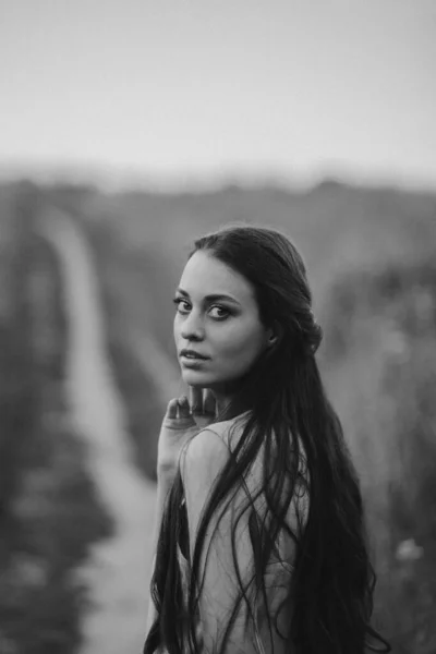 black and beautiful young woman in a long dress in the countryside