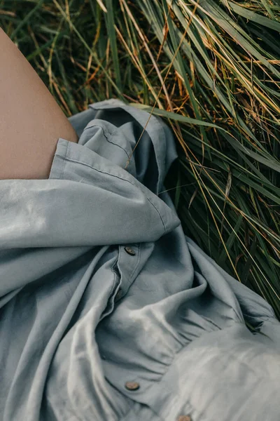 a closeup shot of a beautiful woman lying on a grass