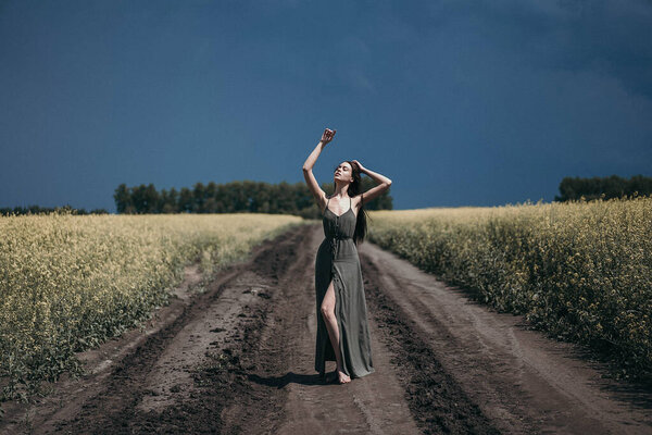 young woman in dress walking in the field