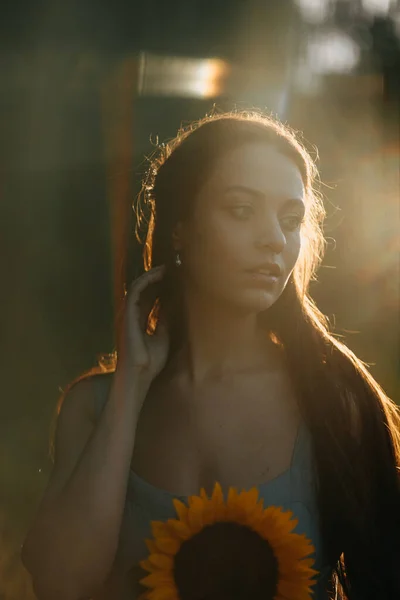 beautiful young woman in a wreath of sunflowers