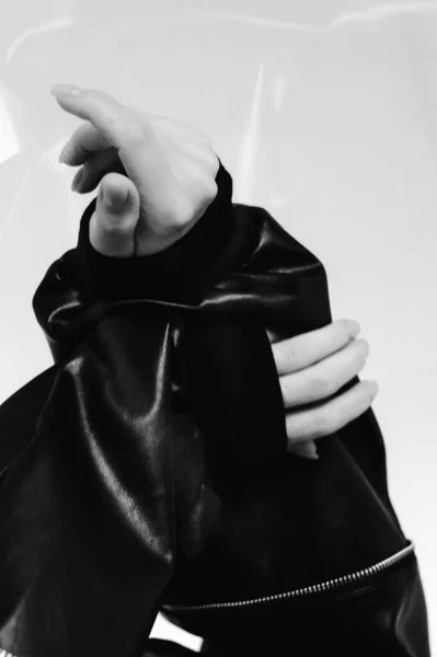 black and white photo of a young woman with a bag of perfume