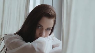 Cute brunette looks at the camera