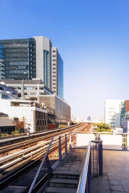 Tren istasyonundan çekilen bu şehirde yüksek binalar var..