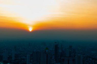 Akşamüstü büyük bir metropolde gün batımı, gün batımının muhteşem manzarası, özellikle odak noktası yok..