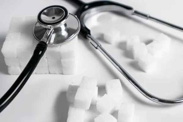 Stock image Background image of sugar cubes and medical stethoscope health care