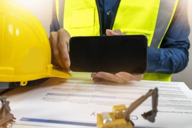 Bir mühendisin grafik ya da metin eklemek için ekranı tuttuğu mobil bir model..