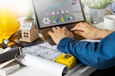 Engineers work on construction drawings and safety systems.,Building construction puts safety first.