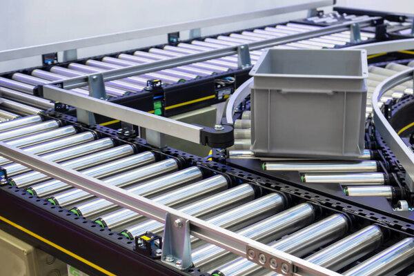 The machinery system for delivering goods in the material warehouse with a sliding mechanism, in a focus view on the sliding equipment.