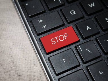 close up of a Red button with stop word on the keyboard . clipart