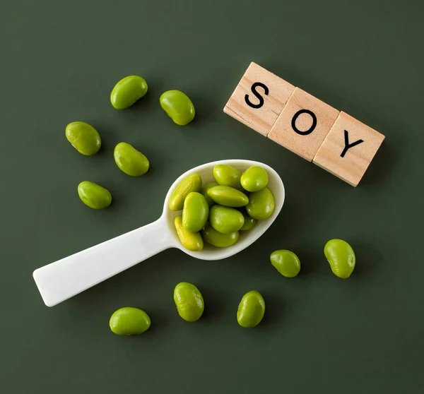 Glycine max - fresh organic soy beans in white spoon