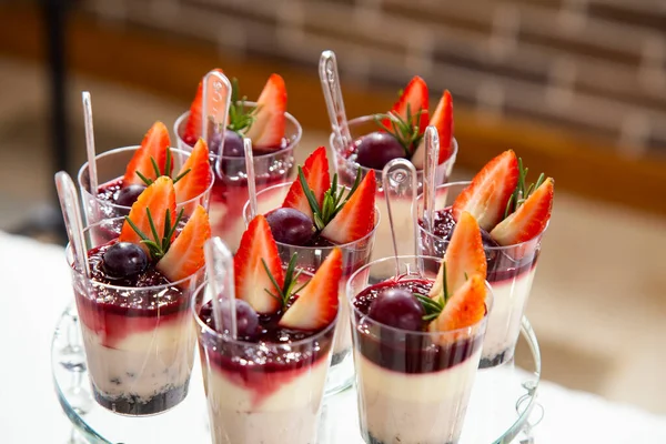 Mousses with berries on the dessert table for a party