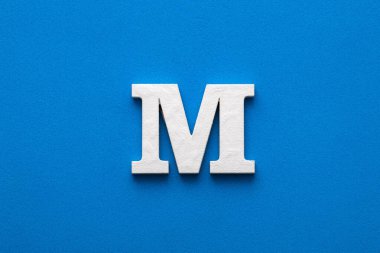 Letter M uppercase - White wood font on blue foamy background