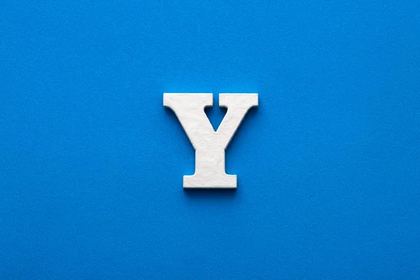 Letter Y uppercase - White wood font on blue foamy background