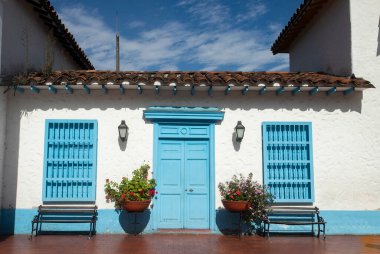 traditional Colombian architecture, white facade with blue door and windows