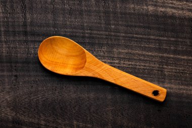 wooden spoon on dark rustic table - Kitchen accessory