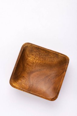 Square wooden bowl on the kitchen table - Kitchen accessory
