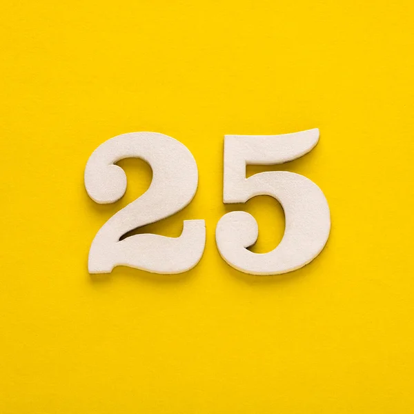 Number 25 - Two figures in white on a yellow background