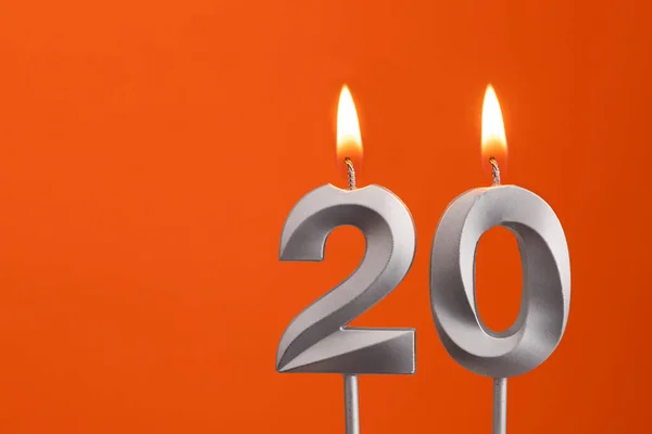 Candle number 20 - Birthday in orange background - Stock Image - Everypixel