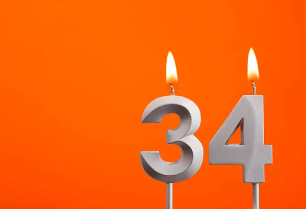 キャンドル番号34 オレンジの背景の誕生日 — ストック写真