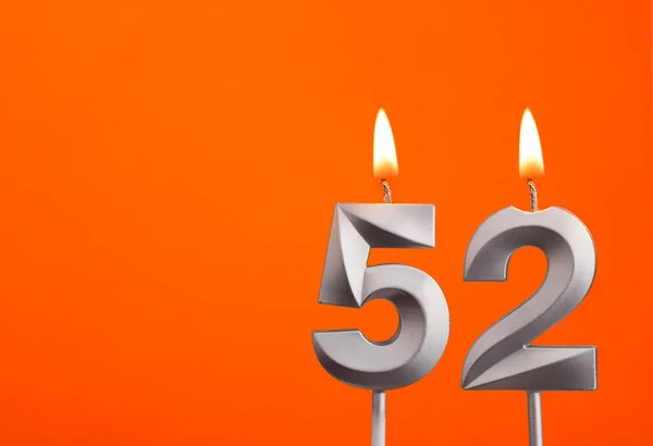 キャンドル番号52 オレンジの背景の誕生日 — ストック写真