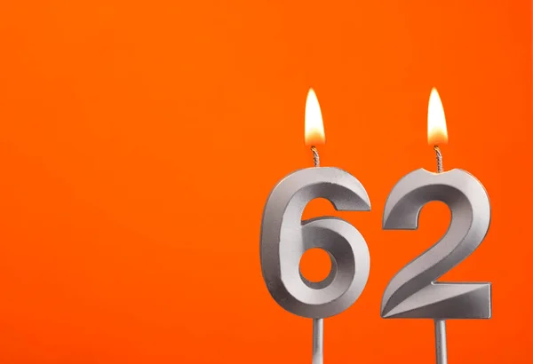 Candle number 62 - Birthday in orange background