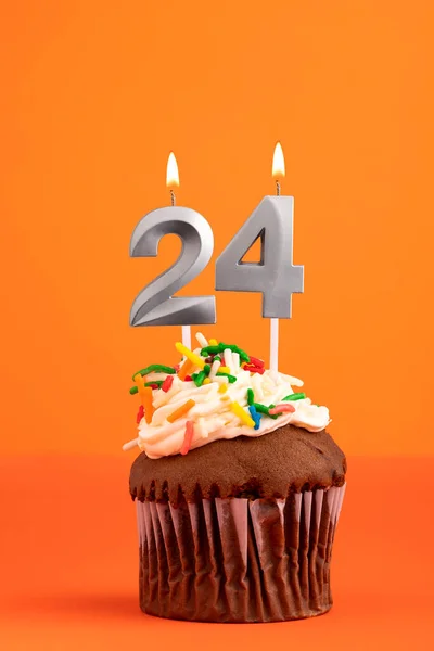 Birthday cake with candle number 24 - Orange foamy background