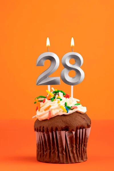 Birthday cake with candle number 28 - Orange foamy background