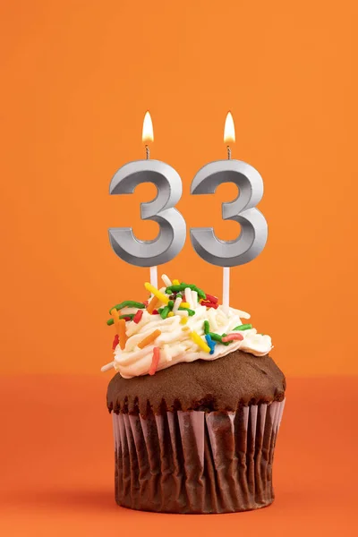 stock image Candle number 33 - Cake birthday in orange background