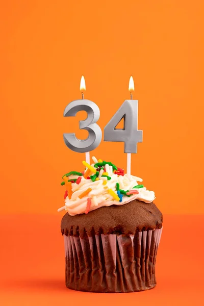 Birthday cake with candle number 34 - Orange foamy background