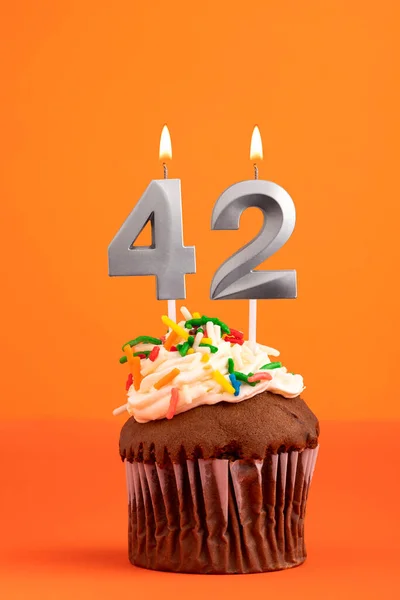 Birthday cake with candle number 42 - Orange foamy background