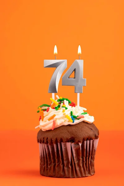 Birthday cake with candle number 74 - Orange foamy background