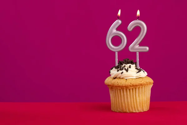 stock image Candle number 62 - Cake birthday in rhodamine red background