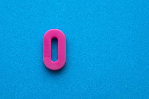 Number Zero Color Pink Plastic Digit Blue Foamy Colored Background — Stock Photo, Image