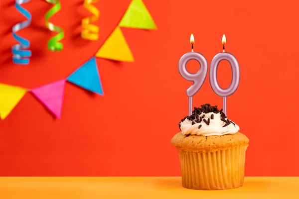 stock image Birthday cake with number 90 candle - Sparkling orange background with bunting