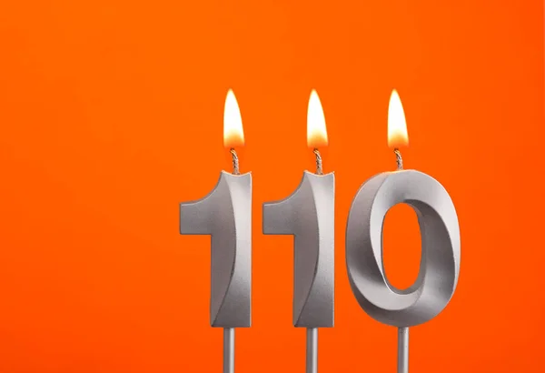 Número Vela 110 Aniversário Fundo Laranja — Fotografia de Stock