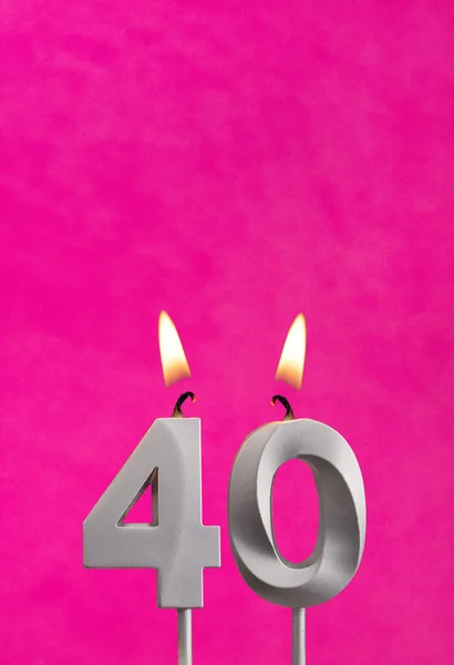Candle 40 with flame - Silver anniversary candle on a fuchsia background