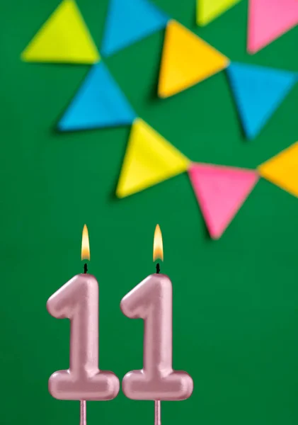 11番キャンドル 緑の背景に誕生日のお祝い — ストック写真