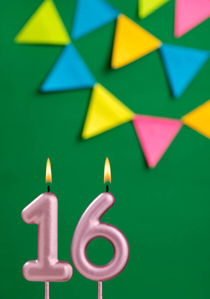 Number 16 birthday candle - Anniversary celebration in green color background