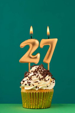 27 numaralı doğum günü mumu - Yeşil arka planlı dikey yıldönümü kartı