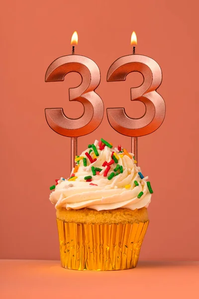 stock image Birthday cake with candle number 33 - Coral fusion background