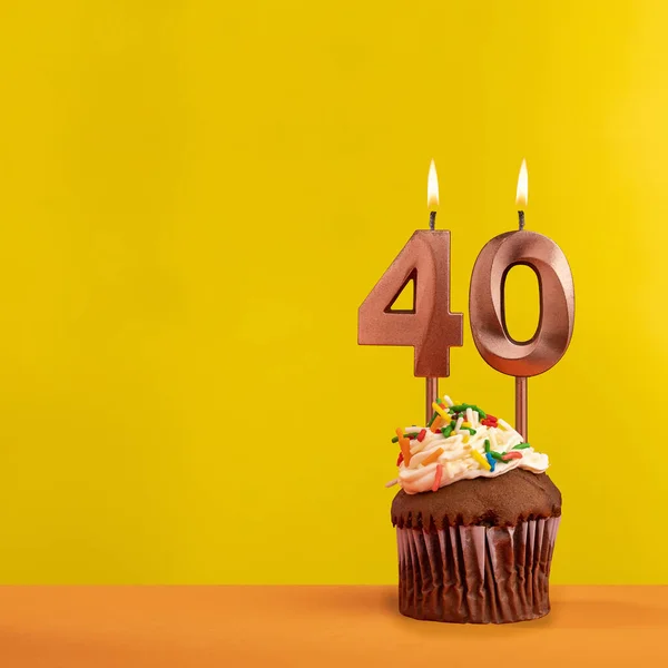 Number 40 birthday candle - Celebration on yellow background