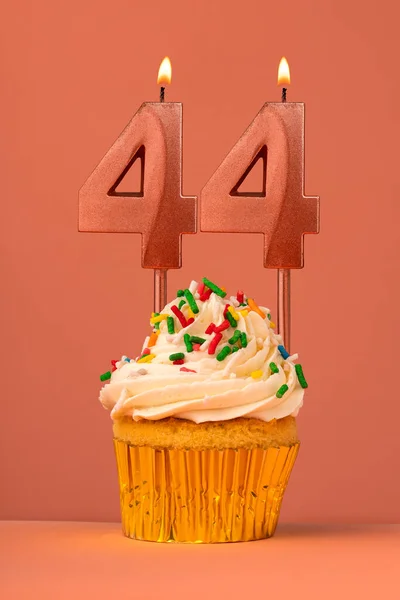 stock image Candle number 44 - Cake birthday in coral fusion background