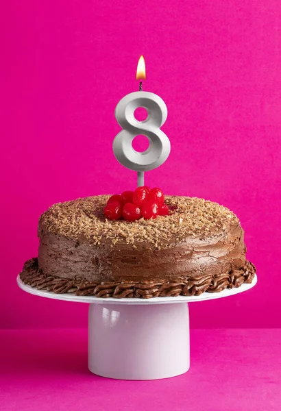 stock image Birthday card with candle number 8 - Chocolate cake on pink background