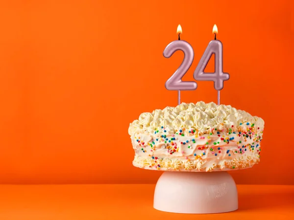 stock image Candle number 24 - Vanilla cake in orange background