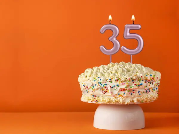 stock image Birthday card with candle number 35 - Vanilla cake in orange background