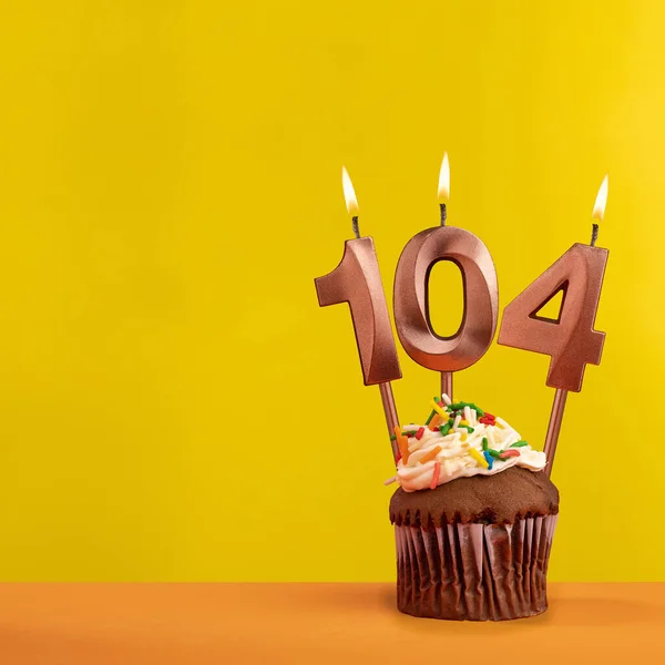 stock image Number 104 birthday candle - Celebration on yellow background