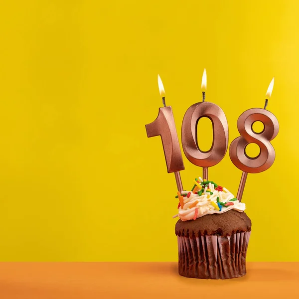 Stock image Number 108 birthday candle - Celebration on yellow background