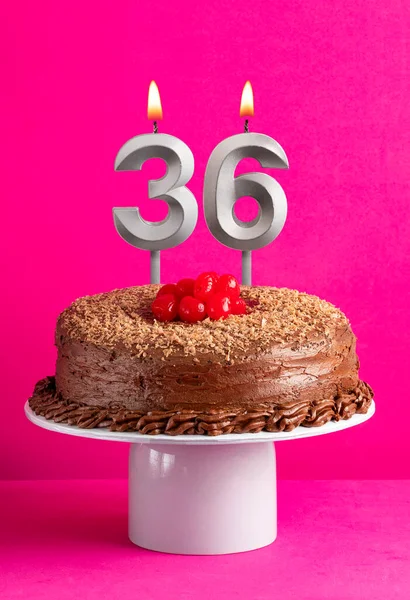 stock image Birthday card with candle number 36 - Chocolate cake on pink background