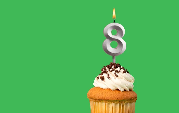 stock image Birthday with number 8 candle and cupcake - Anniversary card on green color background