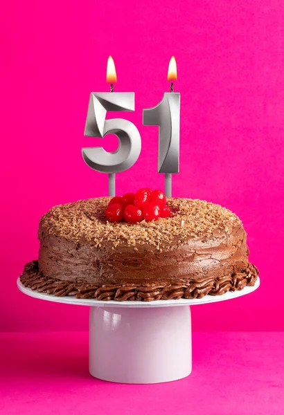 stock image Number 51 candle - Chocolate cake on pink background